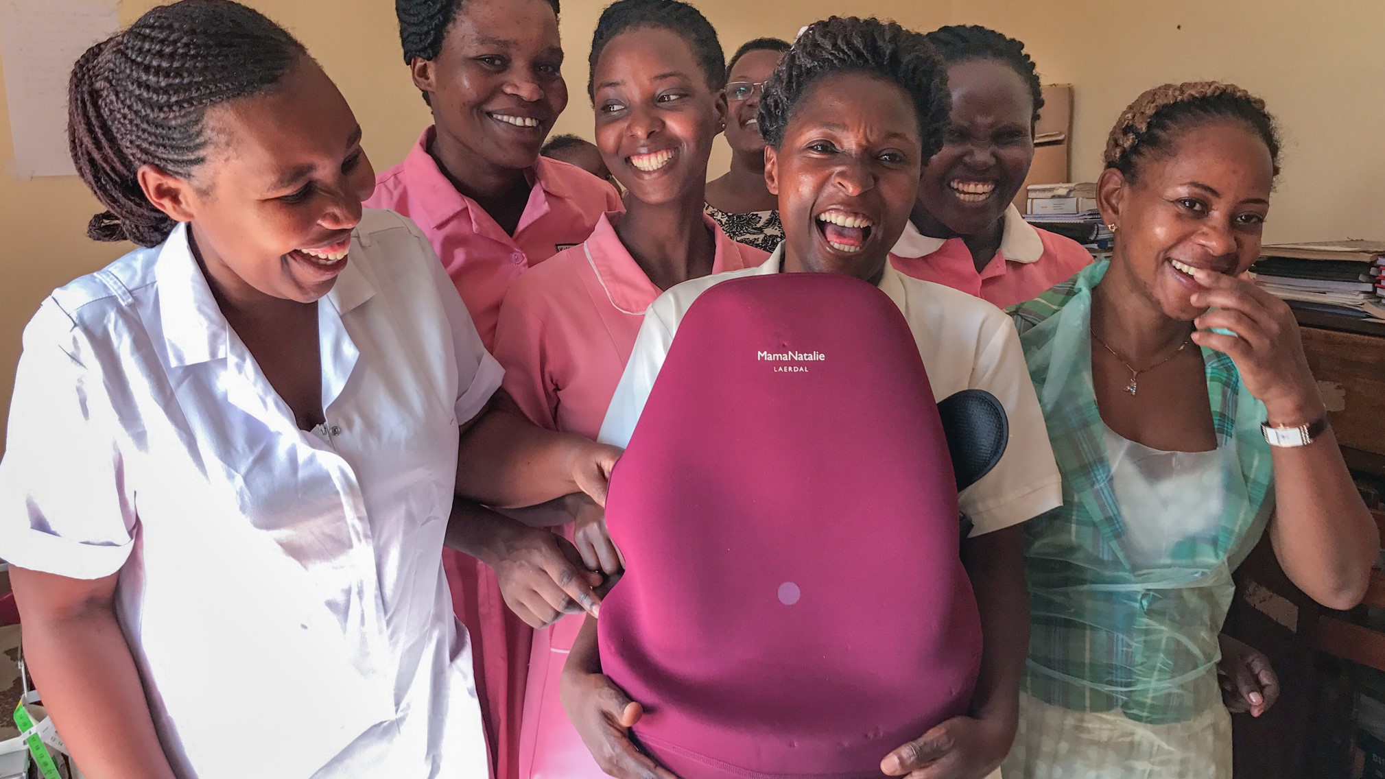 Nurses hold a Mamma Natalie simulation device