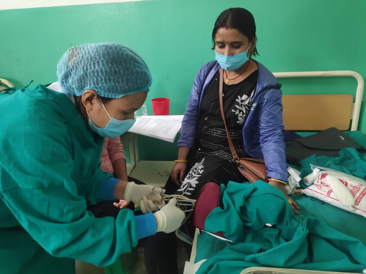 A midwife practices on a Mamma Natalie training device in rural Nepal