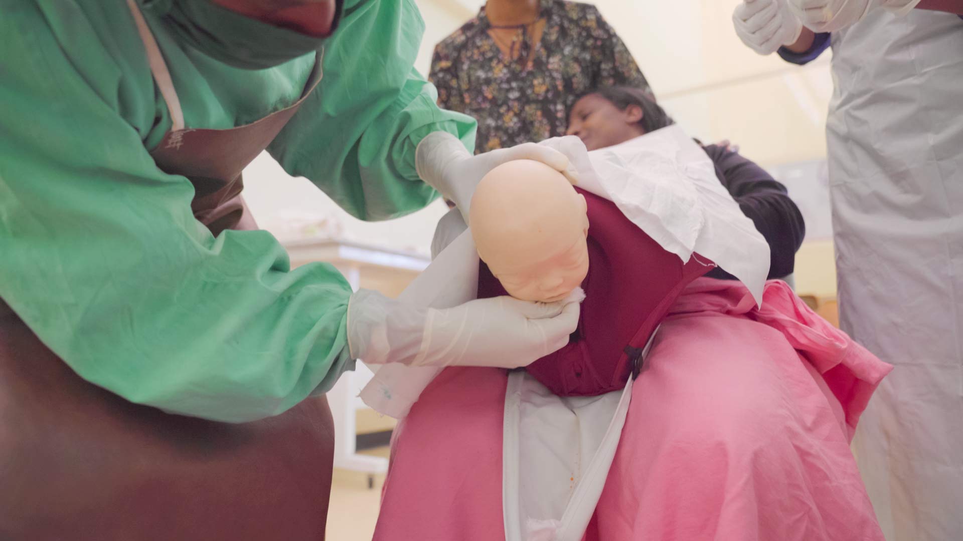 A nurse practices safe delivery with a MamaBirthie Birthing Simulator