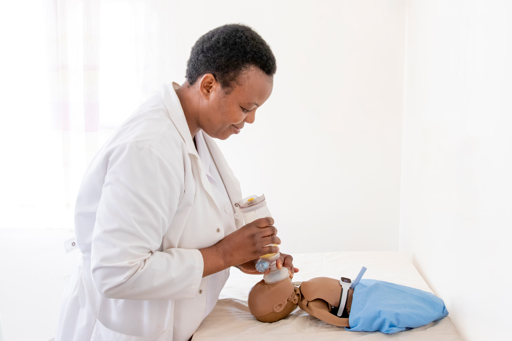 A nurse practices newborn breathing with an upright resuscitator newborn bag-mask