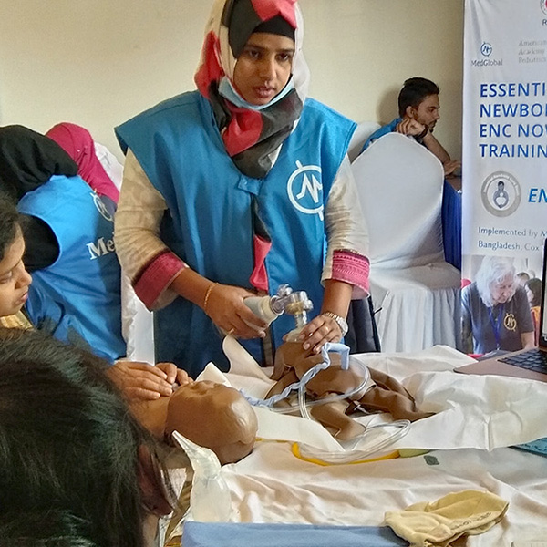 A health care worker practices with a NeoNatalie Resuscitator