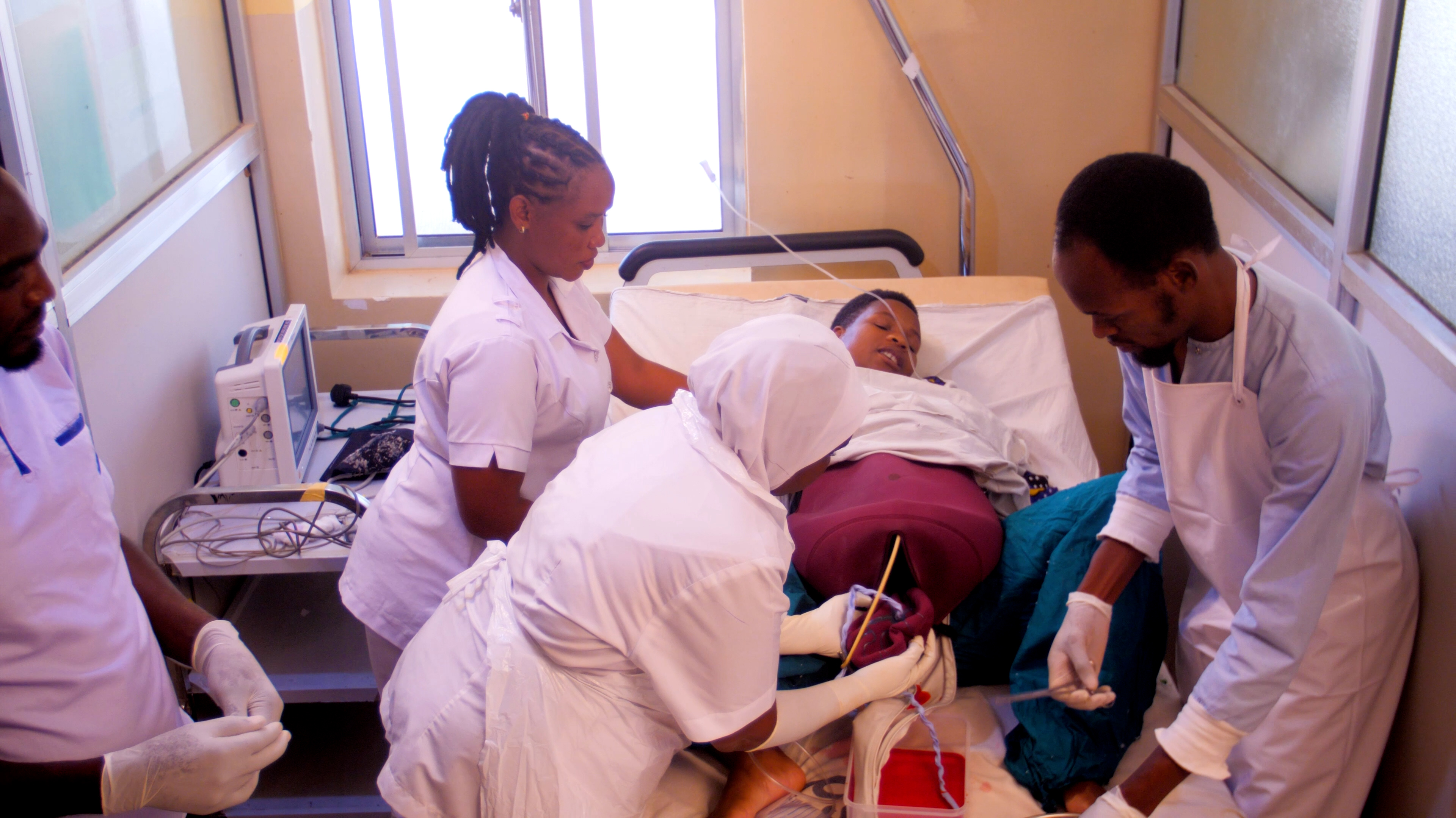 Healthcare workers practice on a laerdal mannikan