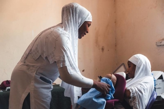 A midwife in Nigeria uses a Laerdal Global Health manikan
